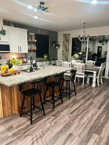 Kitchen island and breakfast bar cleared and cleaned, looking through to the dining room